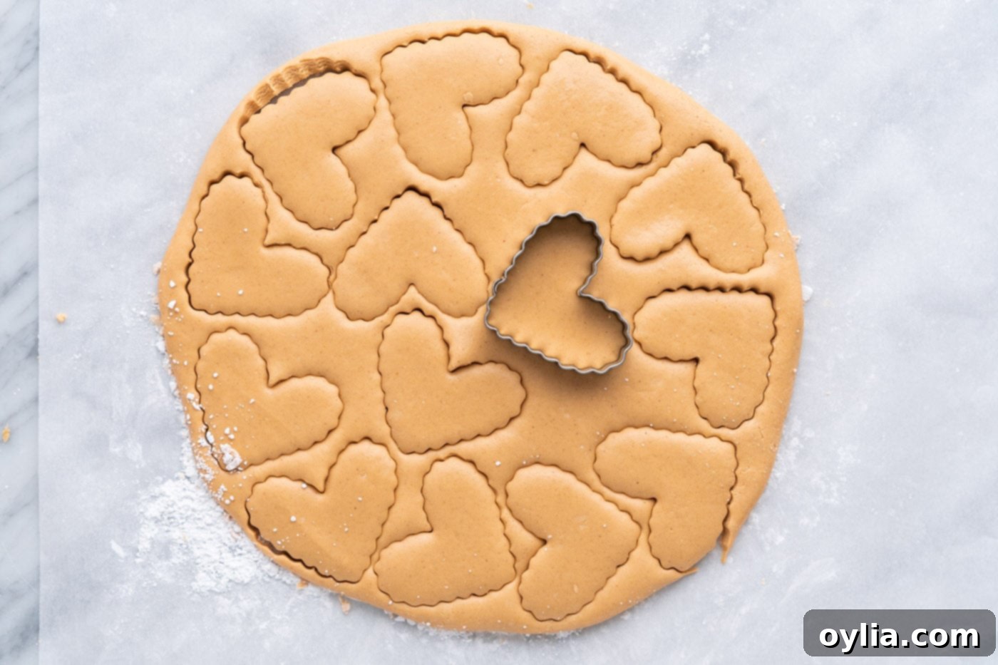 stamping hearts with a cookie cutter into peanut butter dough
