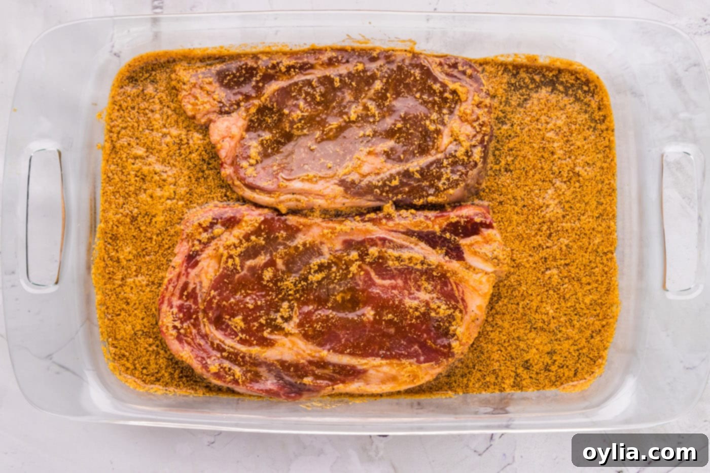 ribeye steak fully soaking in marinade mixture
