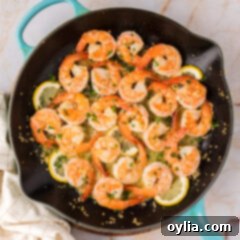 Overhead photo of Garlic Butter Shrimp in a skillet, glistening with sauce and ready to be served.