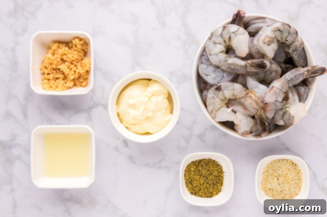 A flat lay photograph of all the ingredients needed for Garlic Butter Shrimp, neatly arranged
