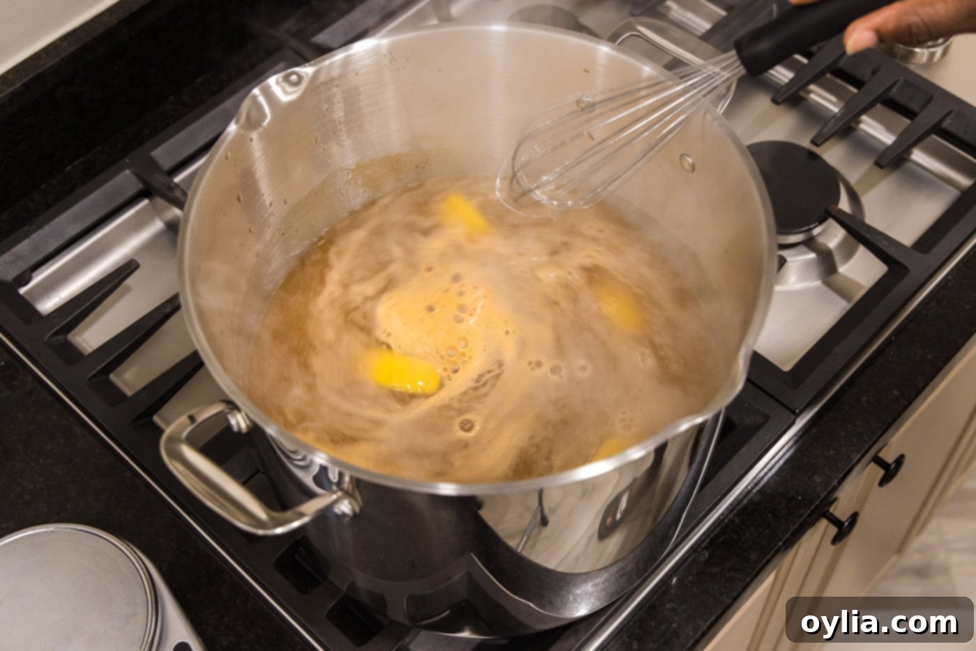 stirring lemon wedges, old bay, and garlic salt in a pot of water