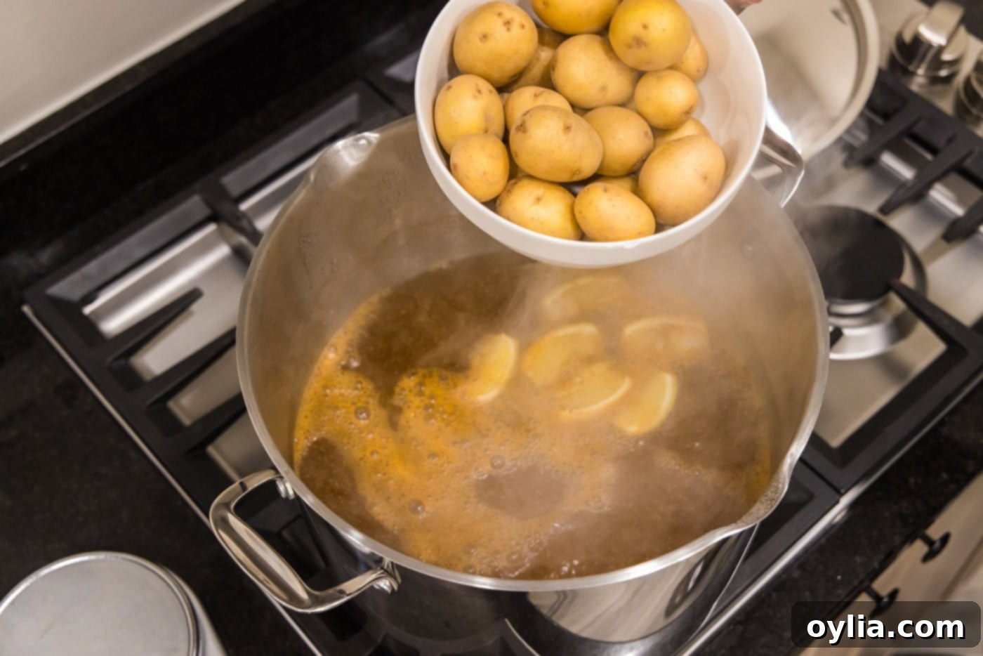 adding yukon gold babay potatoes to a pot of boiling water