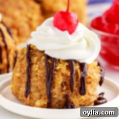 Crispy Shell, Creamy Core 15 Close up of Fried Ice Cream on a plate with chocolate sauce, whipped cream and a cherry on top.