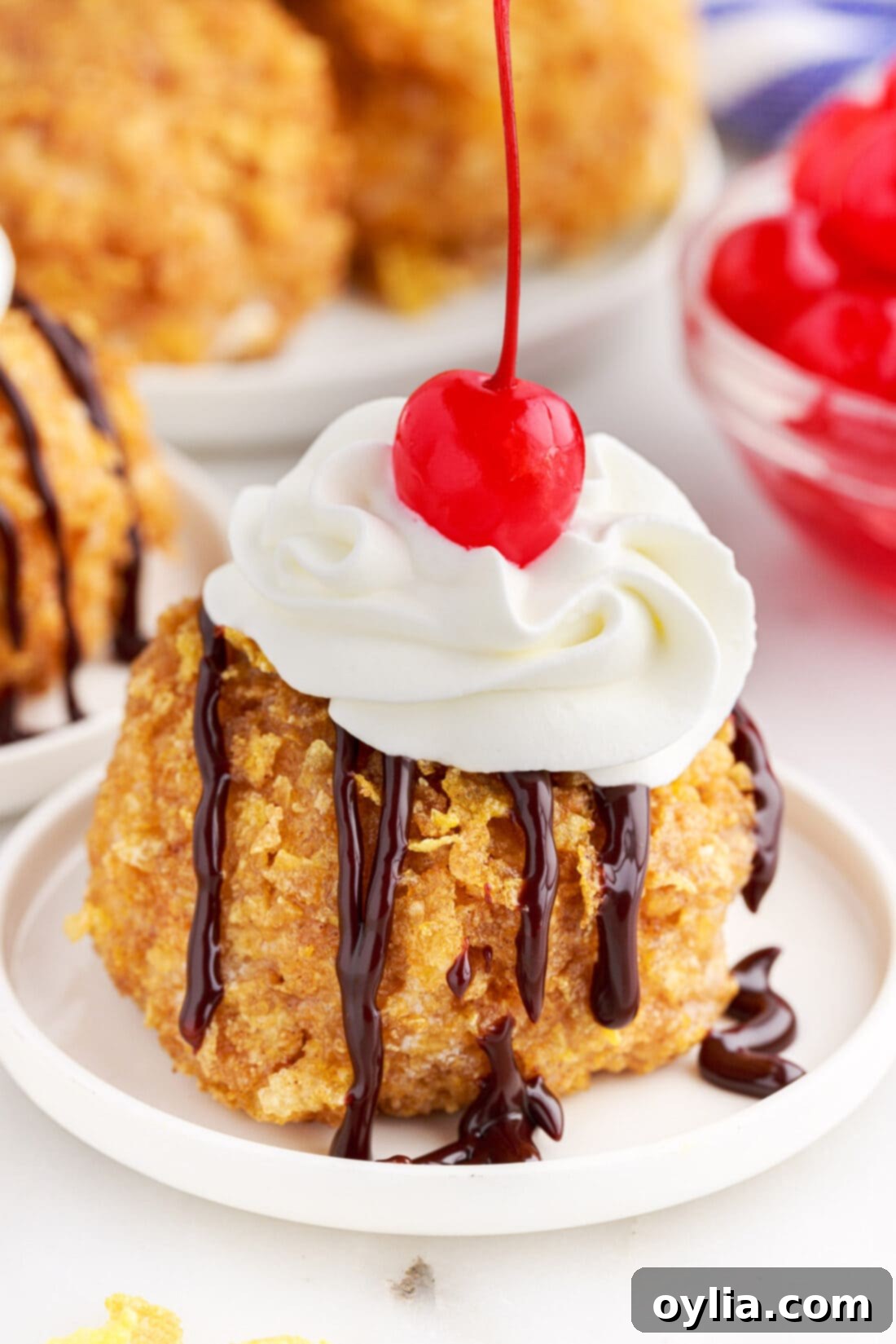 Crispy Shell, Creamy Core 3 Fried Ice Cream on a plate with whipped cream and a cherry on top
