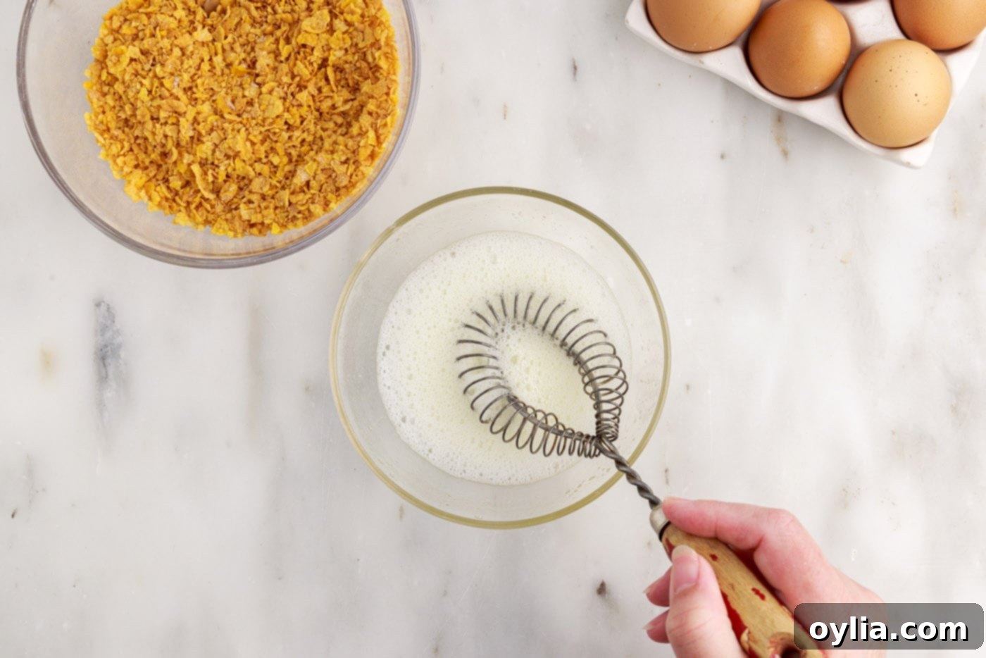 frothing egg whites in a bowl