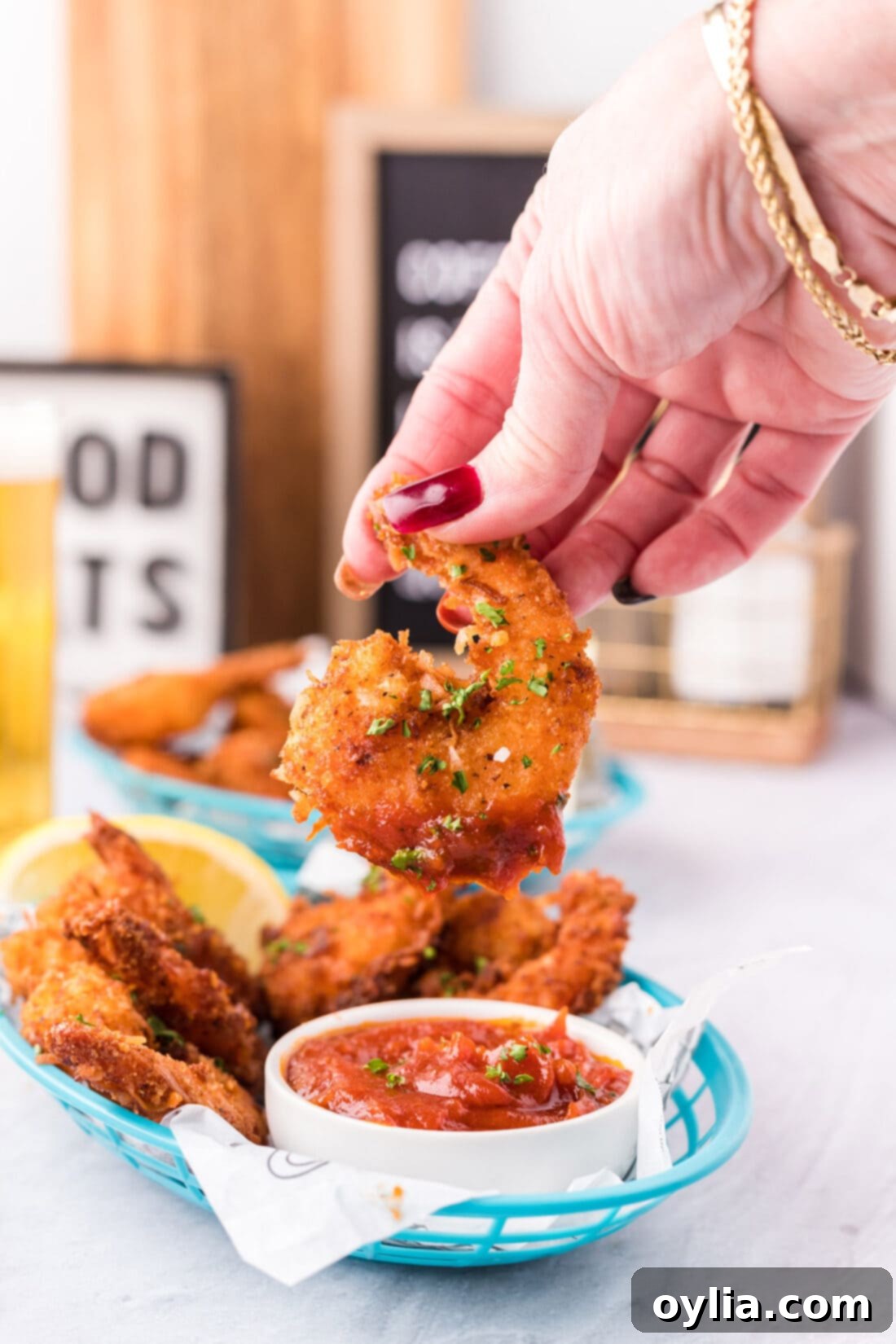 Coconut Shrimp dipped in cocktail sauce
