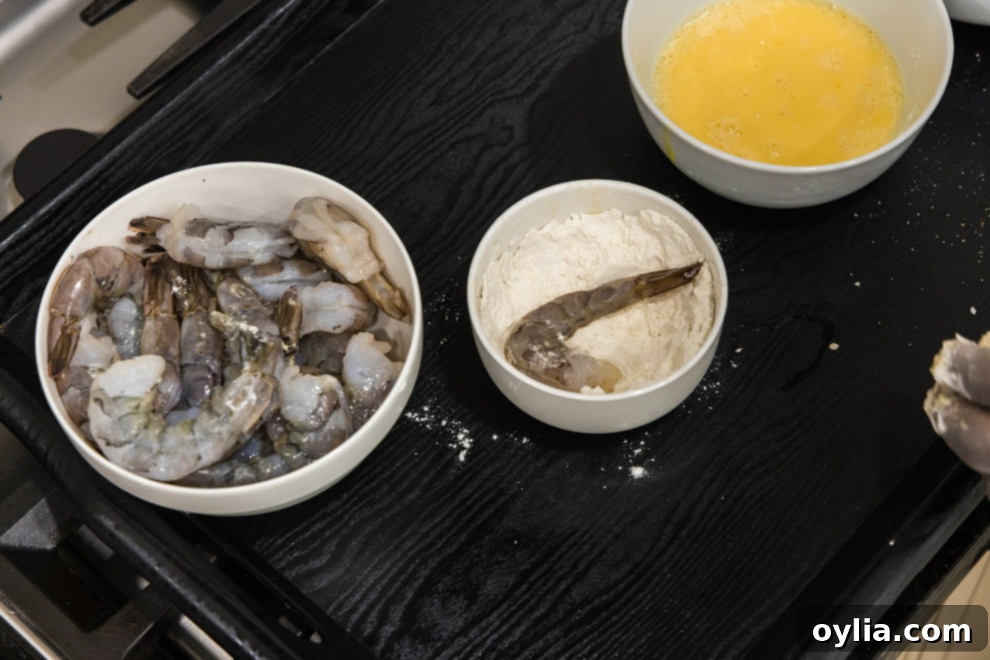 dipping shrimp into flour