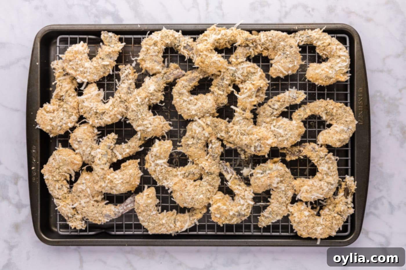 coconut panko coated shrimp on a baking sheet