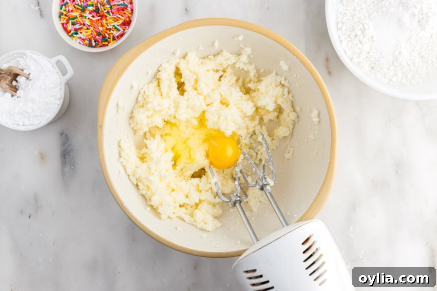 beating egg into butter and sugar mixture