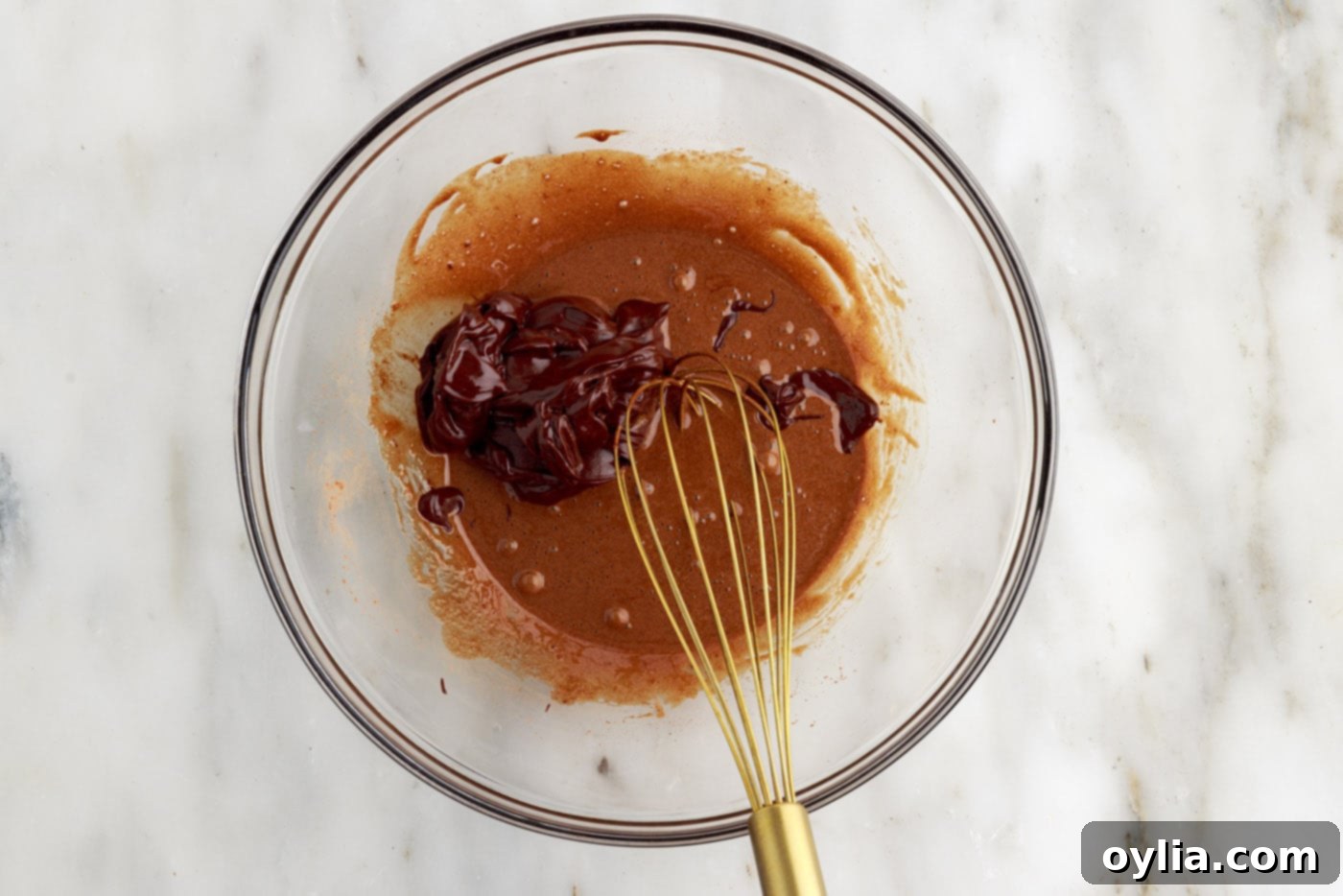 Molten Chocolate Delight 11 whisking chocolate batter and melted chocolate mixture in a bowl
