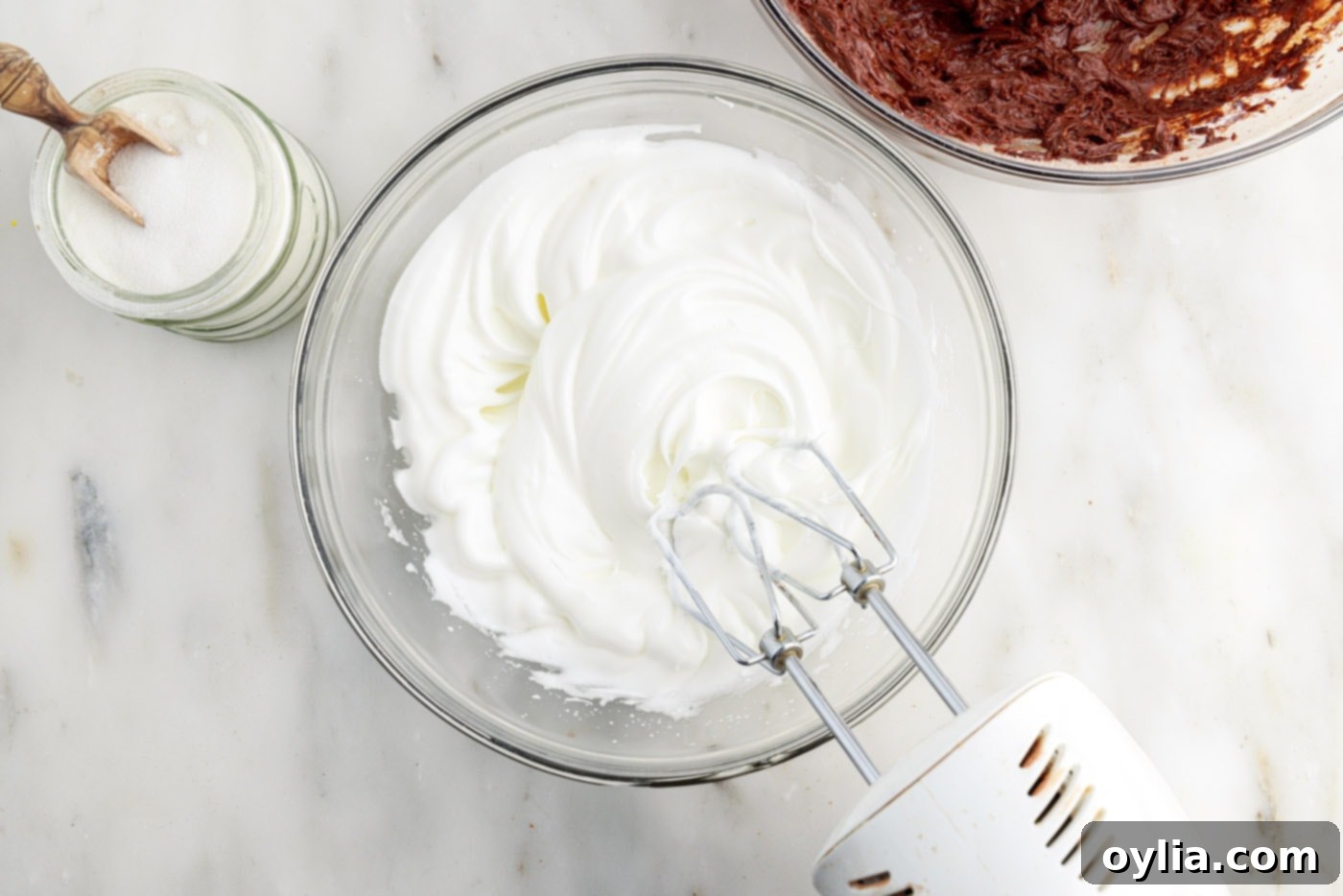 Molten Chocolate Delight 8 whipped egg whites forming stiff peaks in a mixing bowl