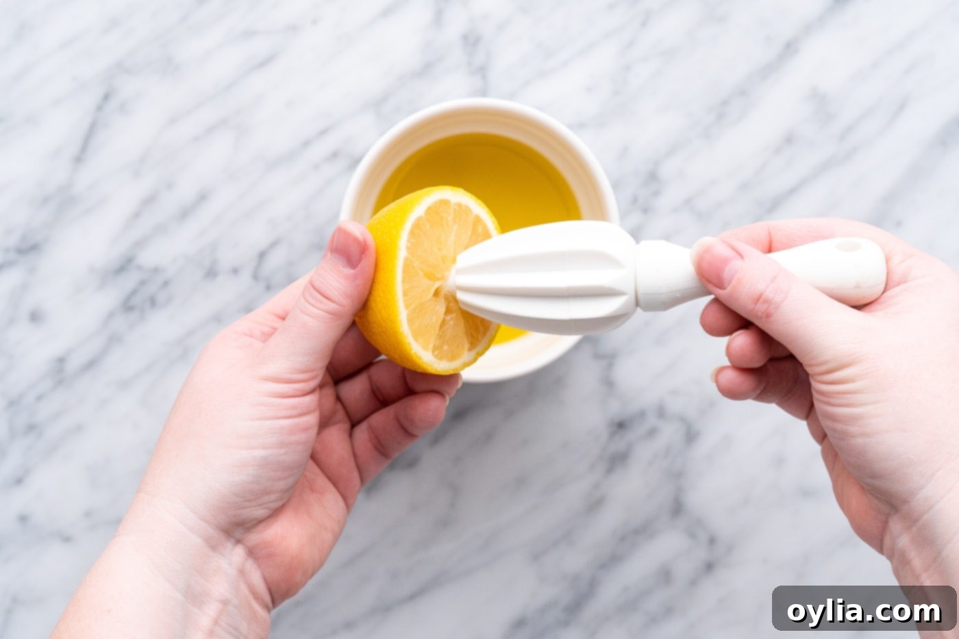 Squeezing fresh lemon juice into a bowl for salad dressing