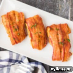 Platter of golden brown bacon wrapped chicken breasts, garnished and ready to serve