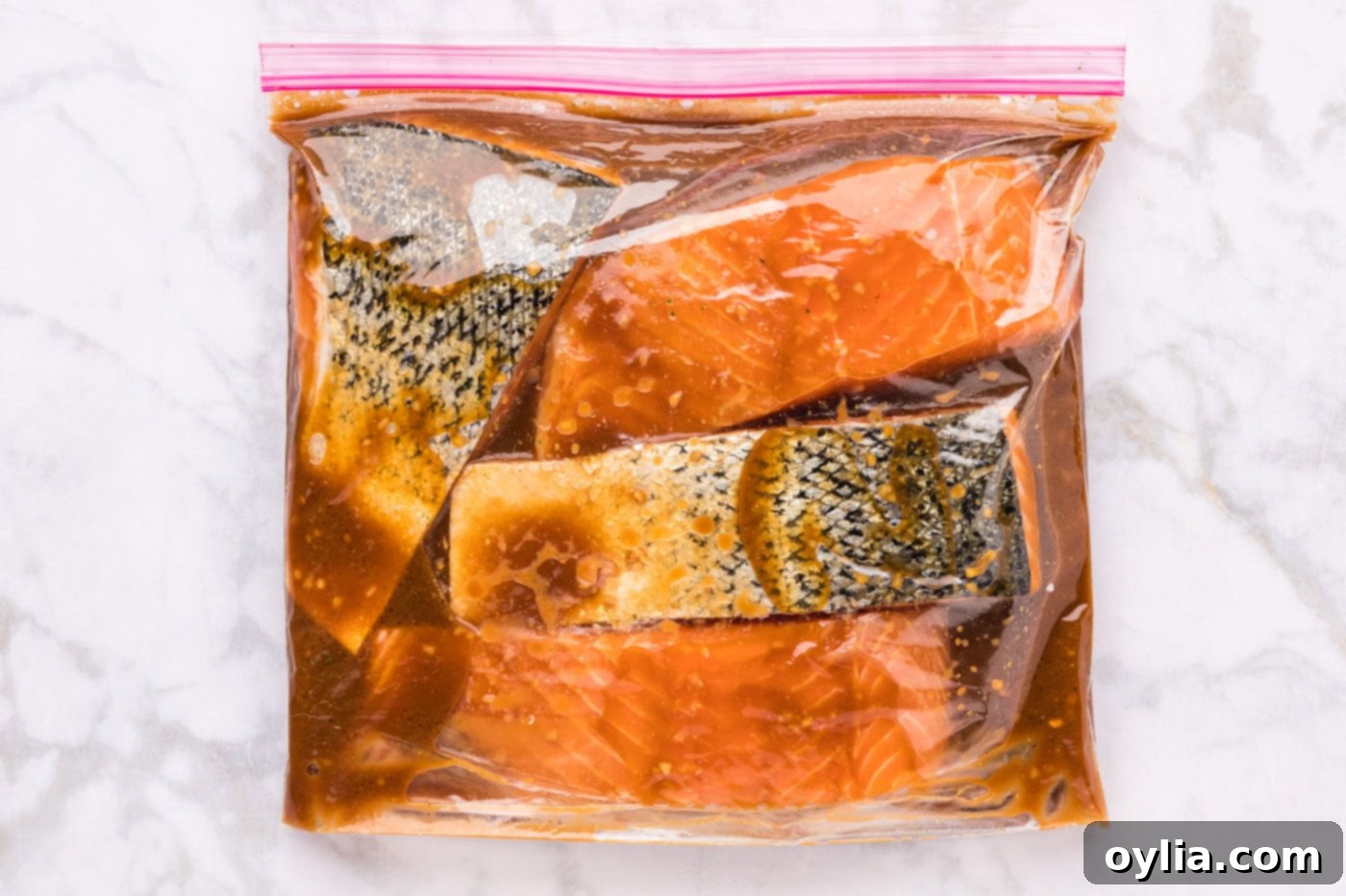 marinating salmon in teriyaki sauce in a zip-top bag