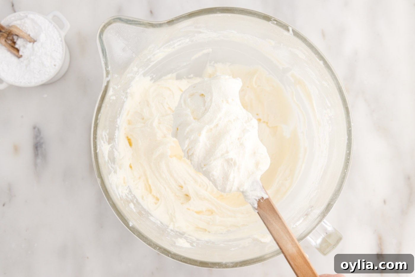 cream cheese frosting on a spatula