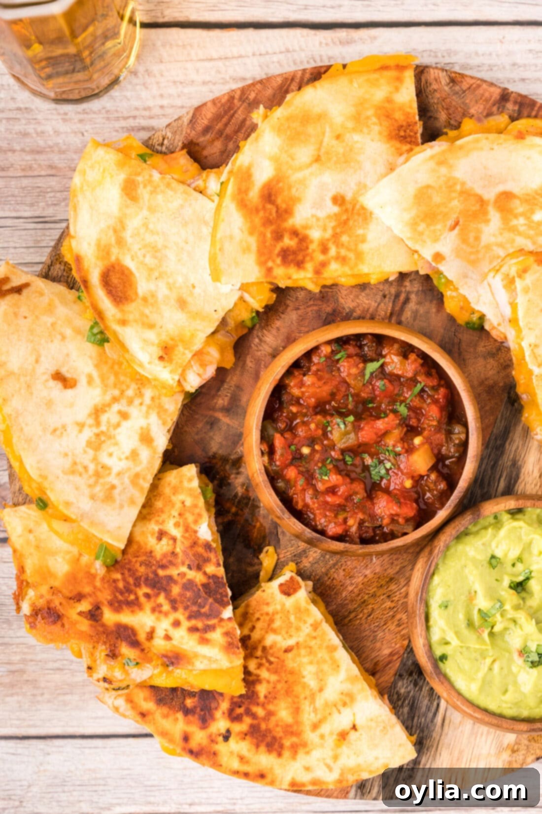 Platter of golden-brown Shrimp Quesadillas, sliced into triangles and ready to serve.