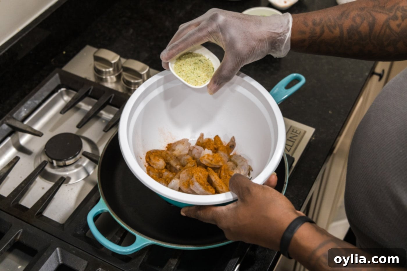 adding garlic salt to shrimp in a bowl for seasoning