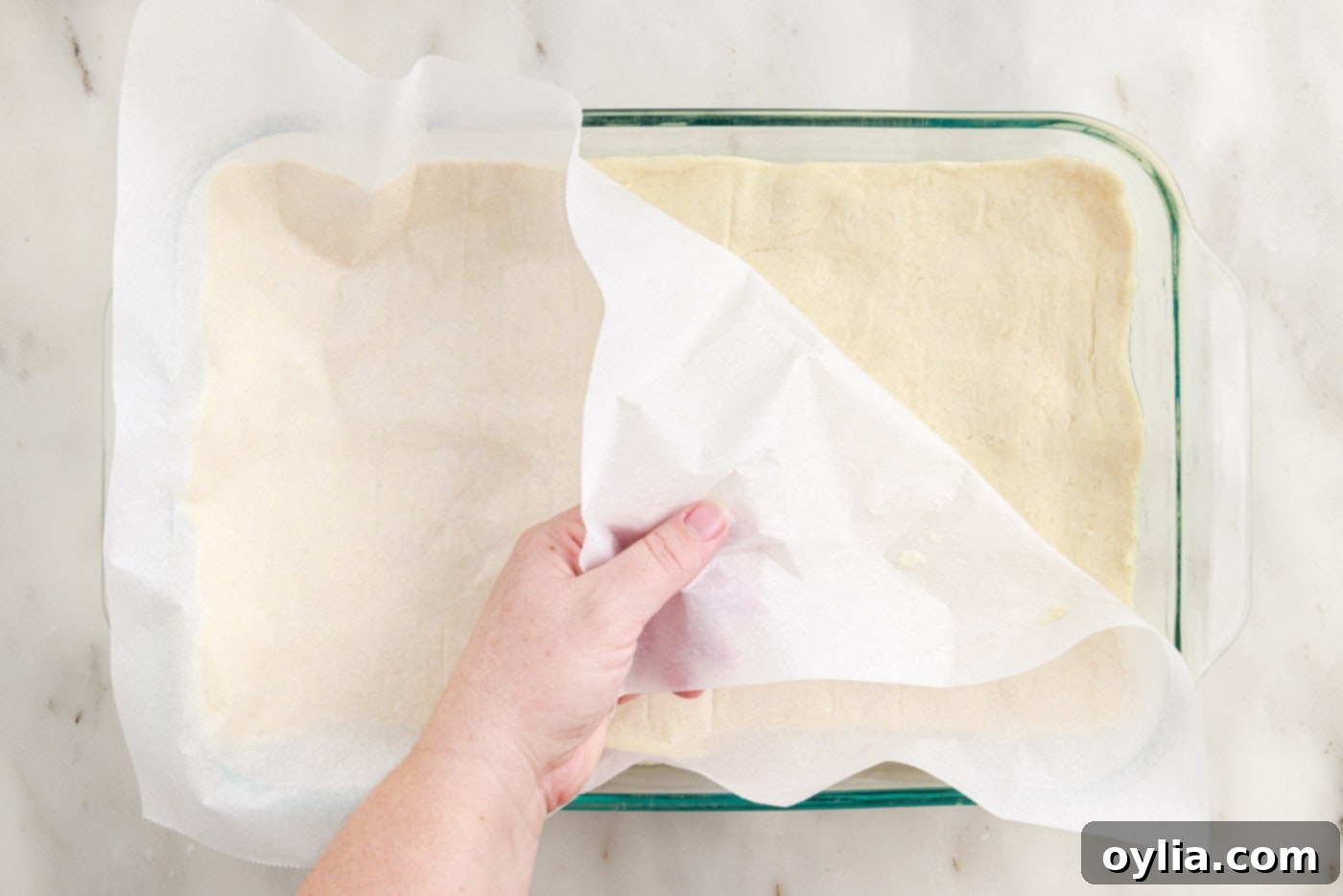 peeling parchment paper off the bottom of crescent dough