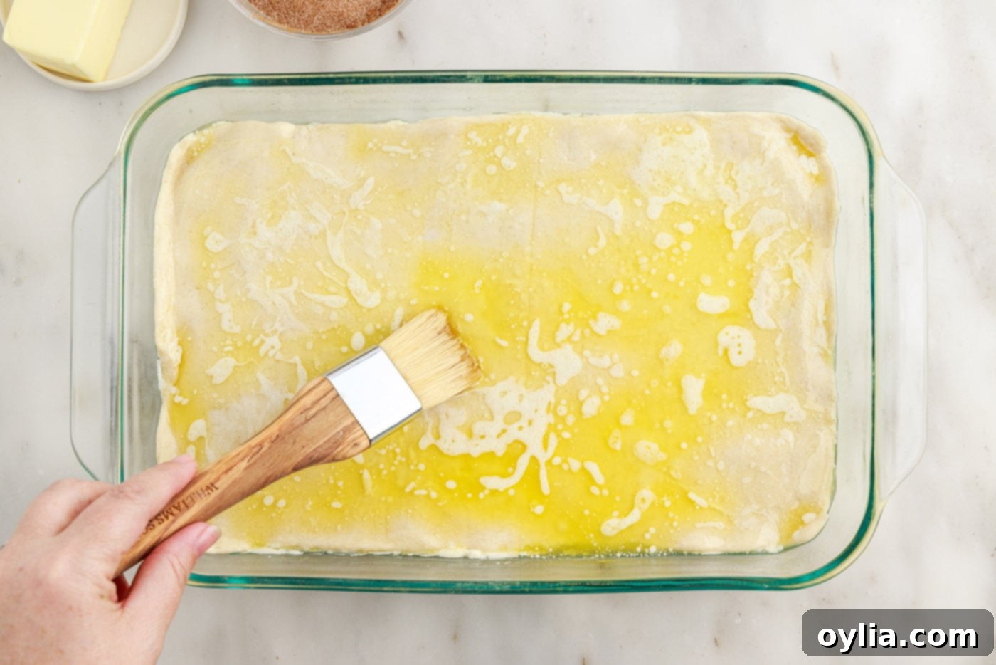 spreading butter over crescent dough sheet