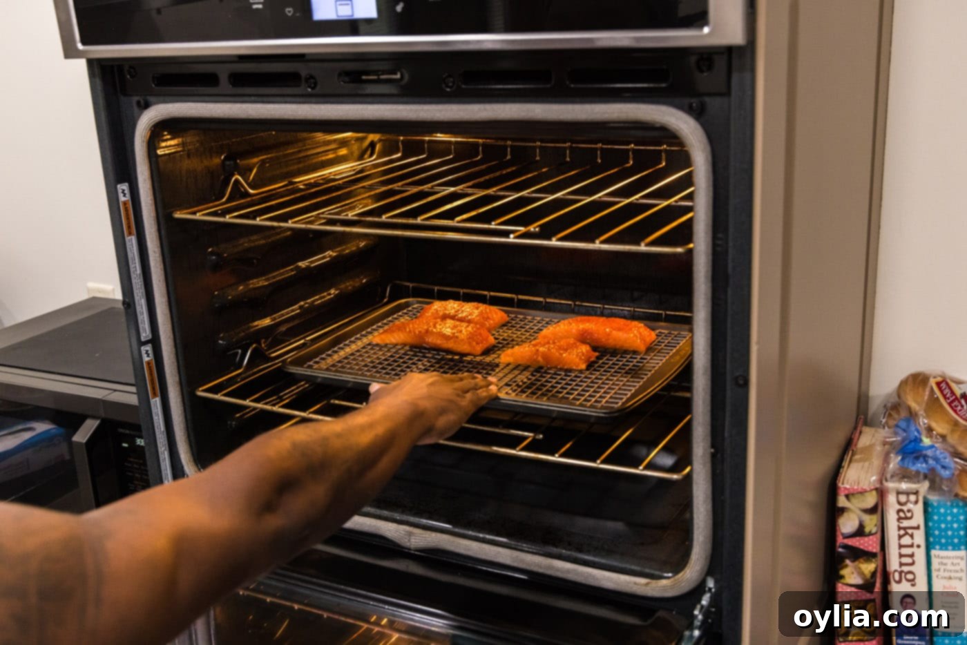 placing salmon filets in oven to roast