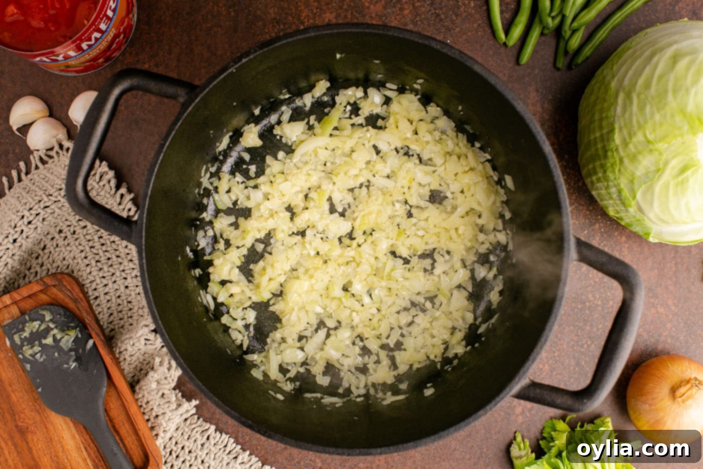 Sautéed onion and garlic, softened and fragrant, forming the aromatic foundation in the soup pot.