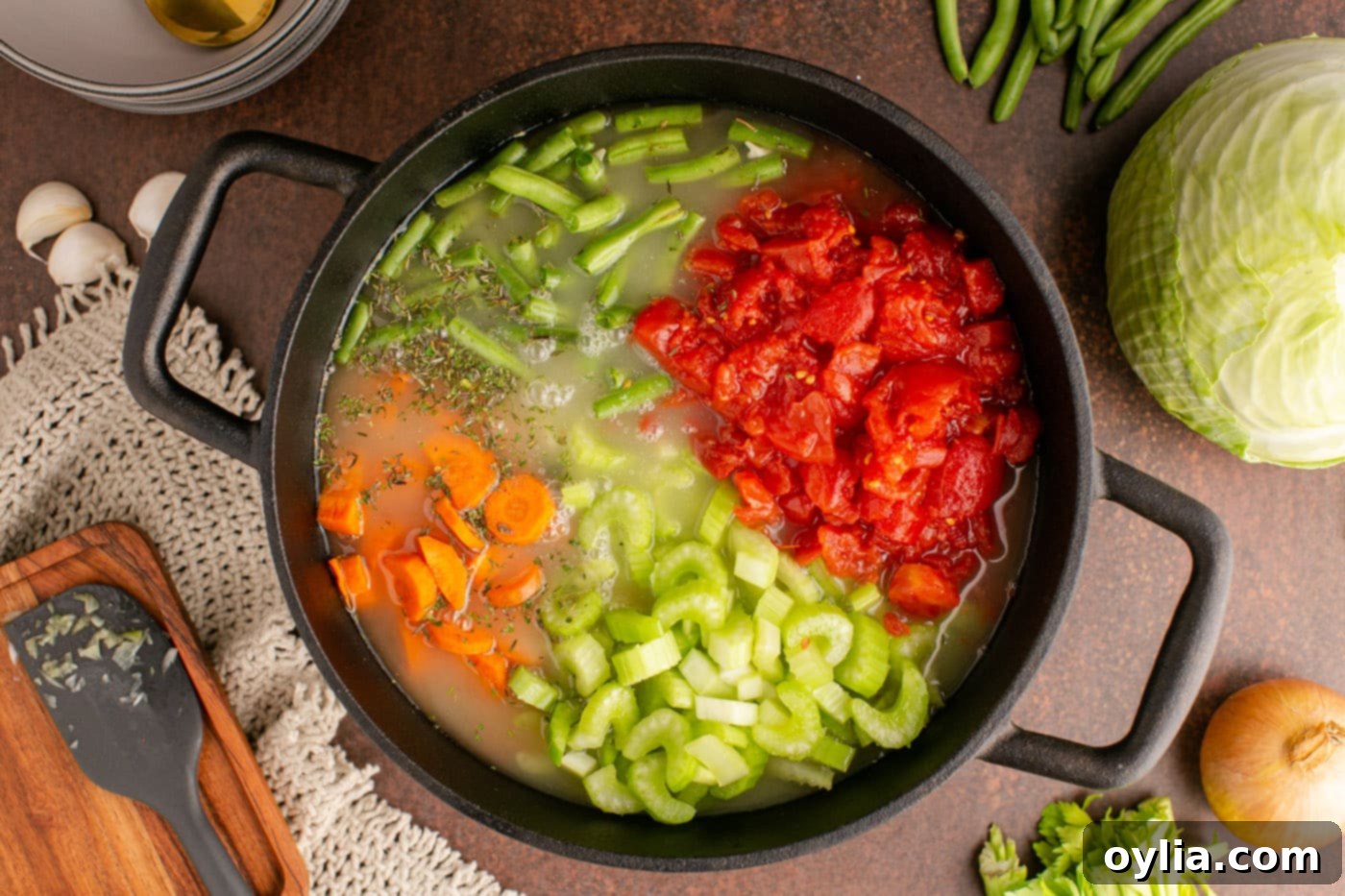 The cabbage soup ingredients in the pot, now covered with vegetable stock and brought to a boil.
