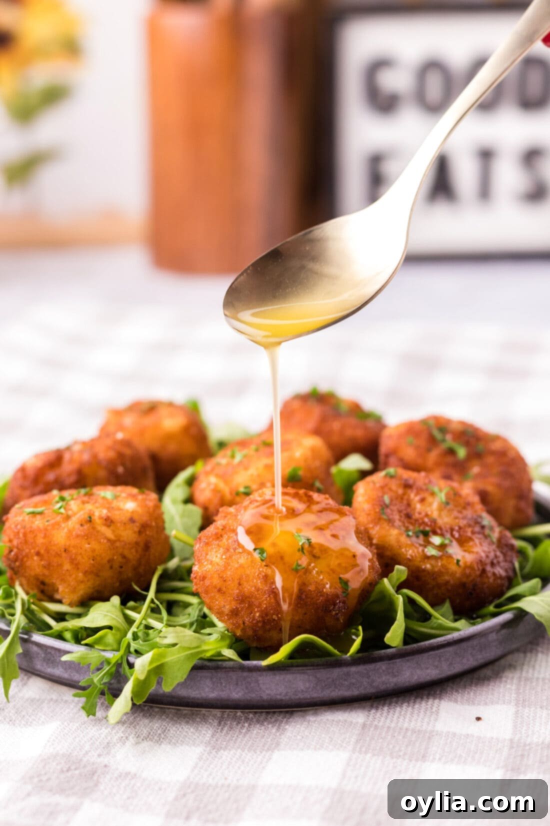 Butter being drizzled from a spoon over Fried Scallops