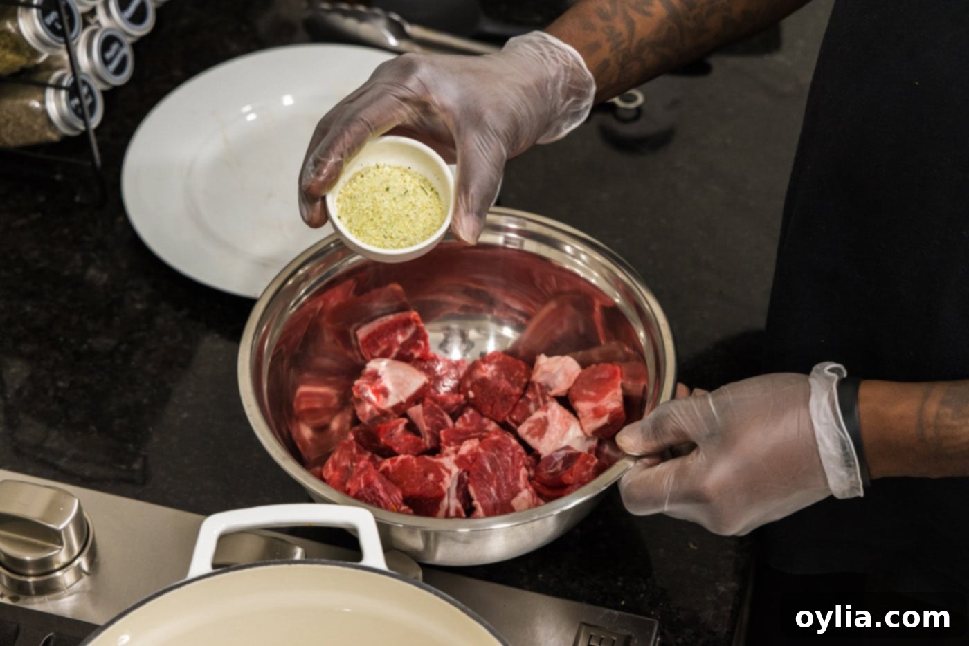 adding garlic salt to cubed chuck roast