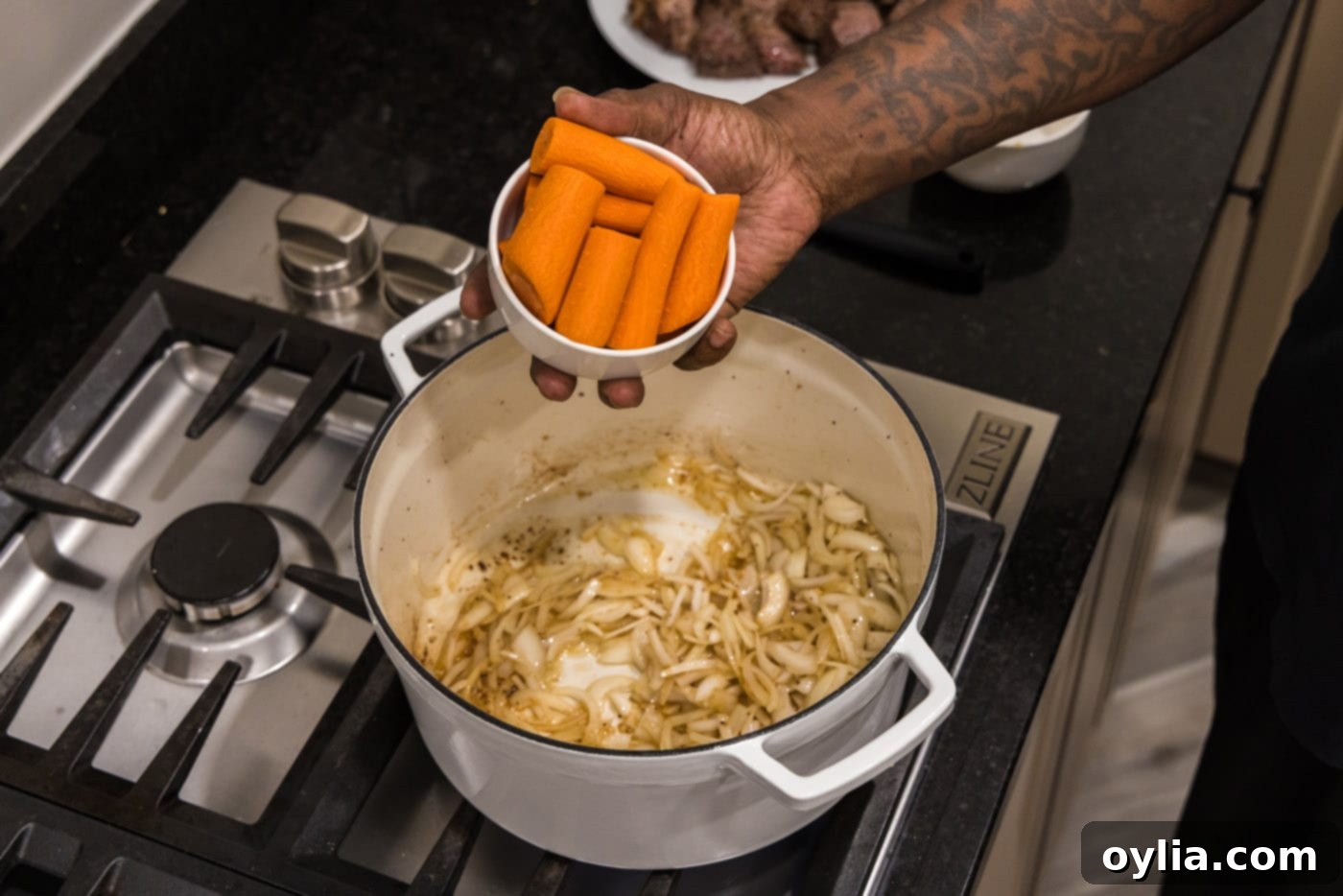 onions and carrots added to dutch oven