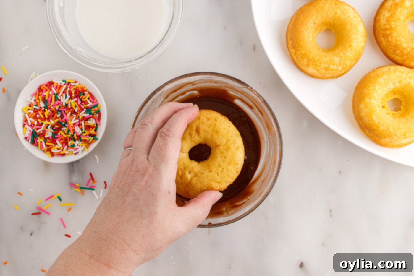 dipping donuts in chocolate glaze