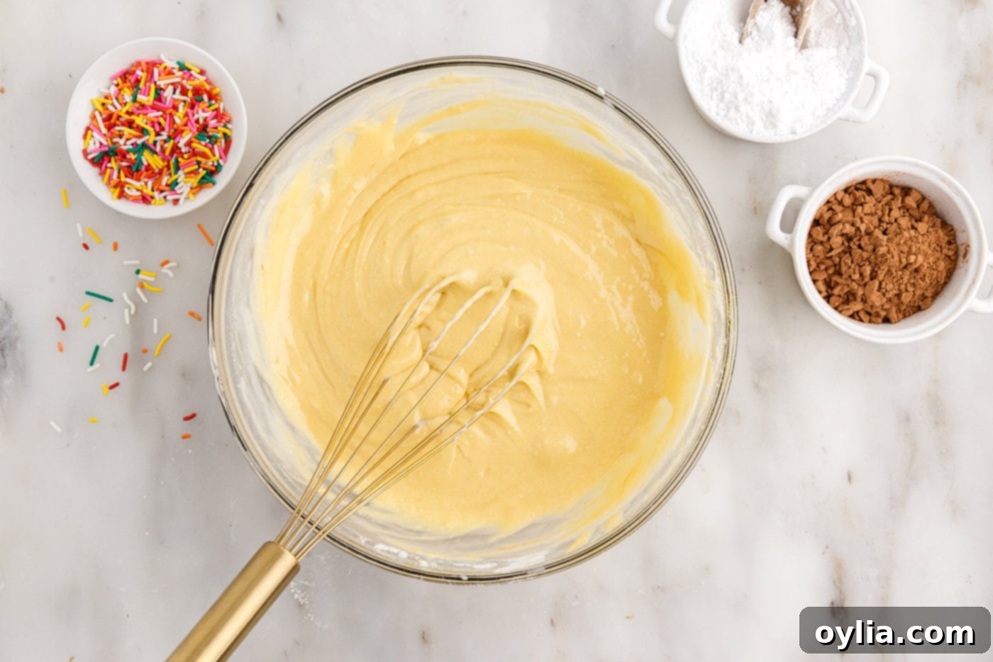 whisking together cake mix with eggs, milk, oil, and sour cream