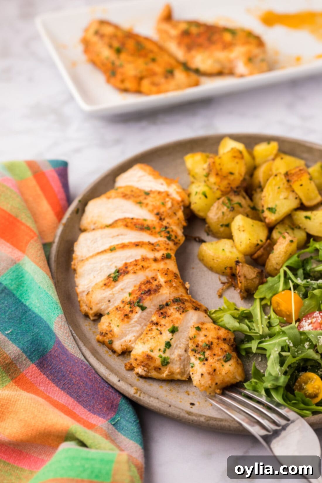 Blackened Chicken on a plate with a salad and potatoes