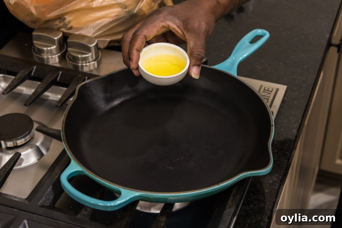 adding oil to a hot skillet