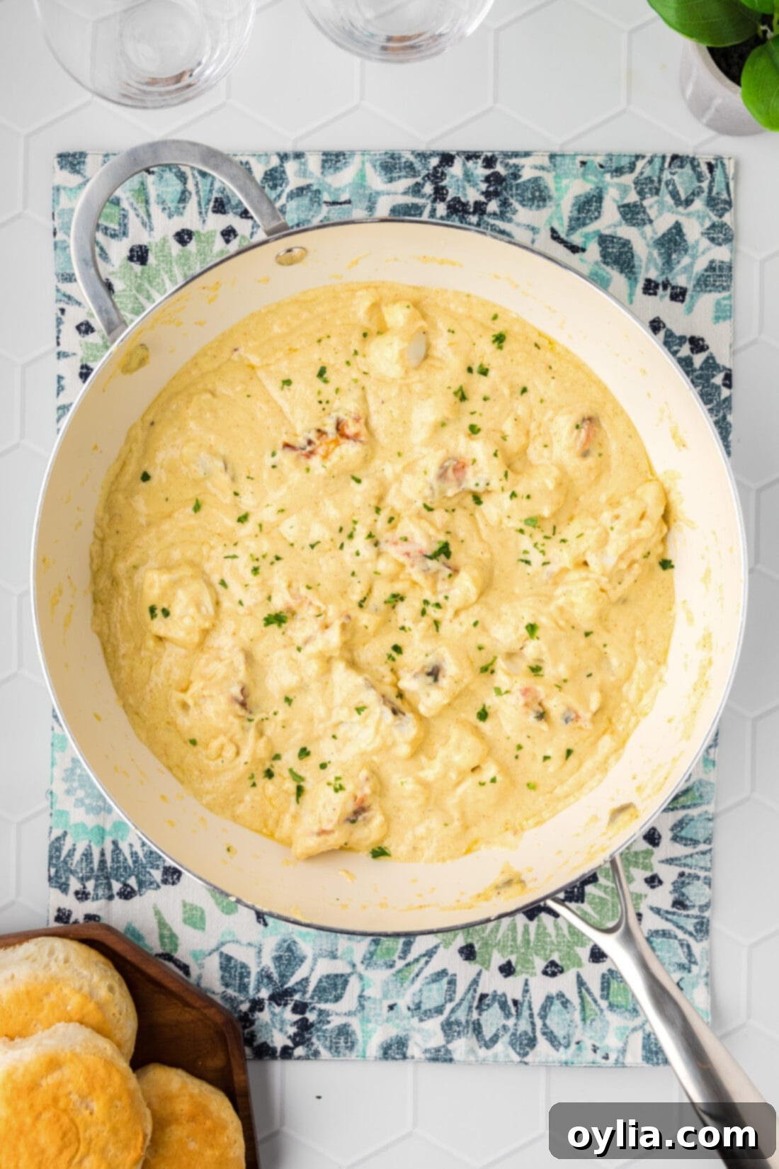 Skillet of Lobster Newburg with biscuits on the side, showcasing its rich, creamy texture and generous lobster pieces.