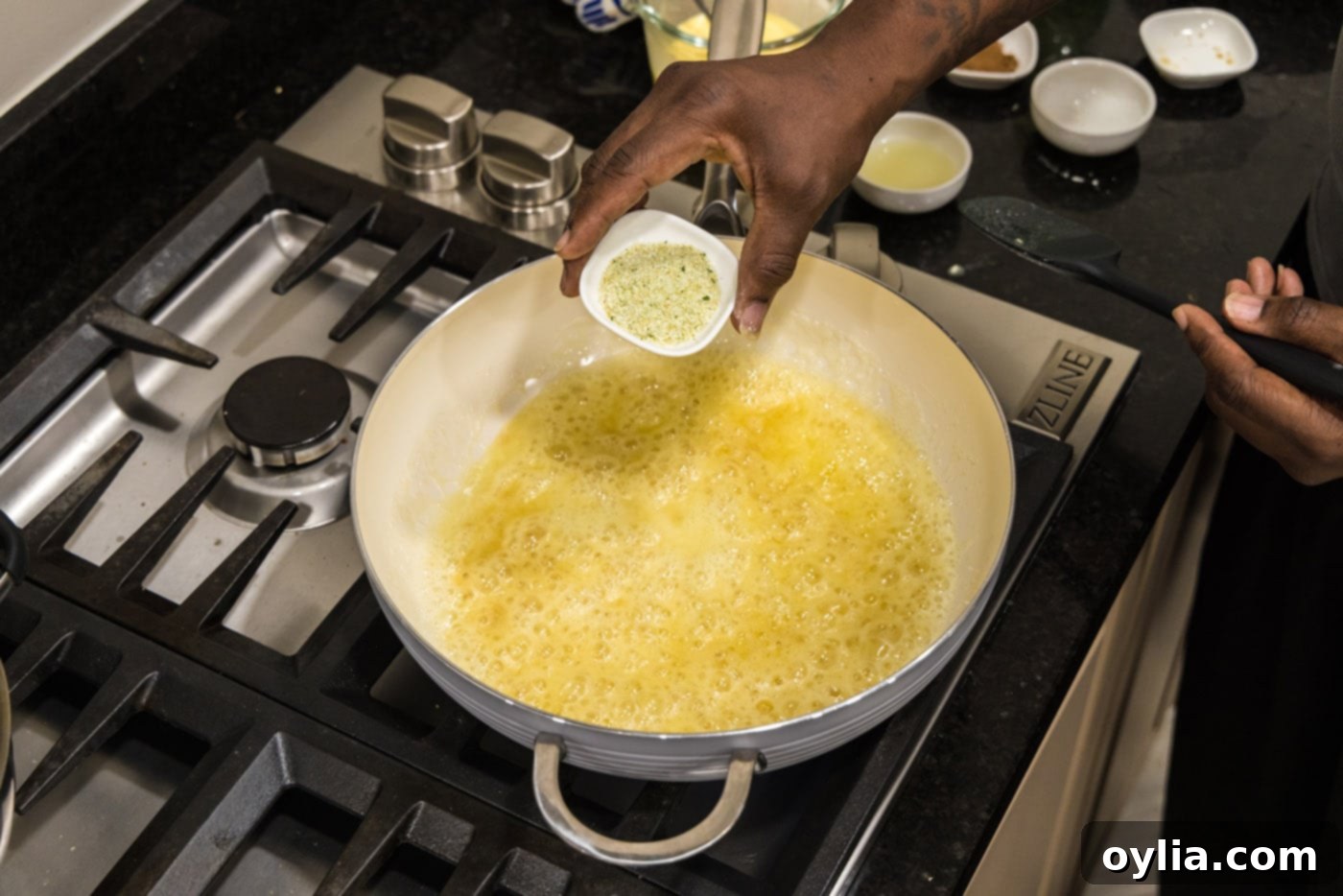 Adding garlic salt to the skillet with the butter-flour mixture, enhancing the savory base of the sauce.