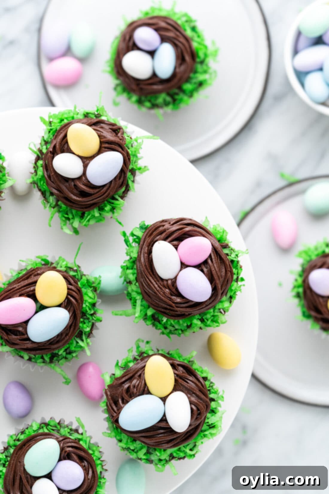 Homemade Easter Nest Cupcakes displayed beautifully on a white cake stand, ready for serving