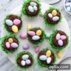 Overhead view of homemade Easter Nest Cupcakes displayed on a white cake stand, ready for serving