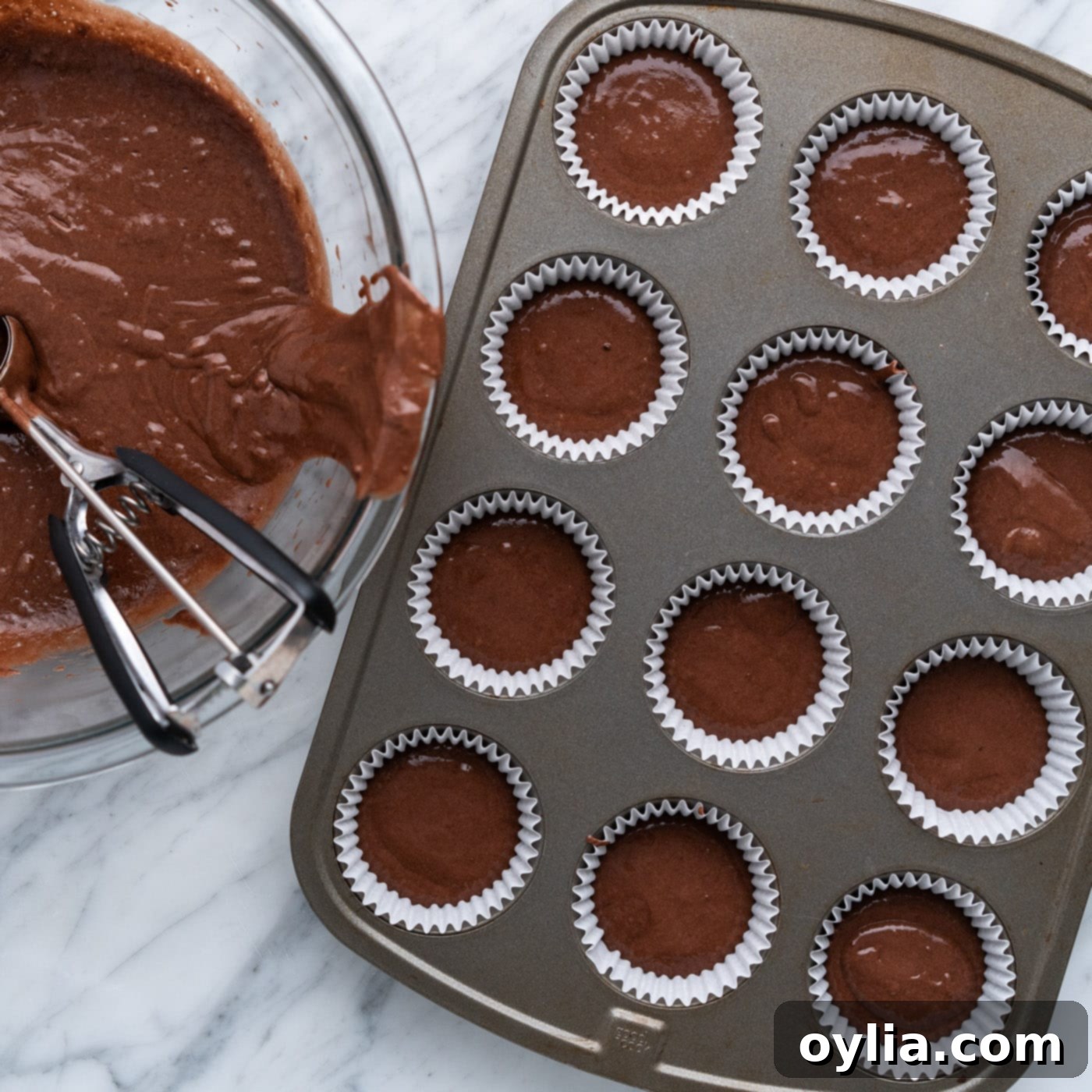 chocolate cupcake batter in a muffin pan