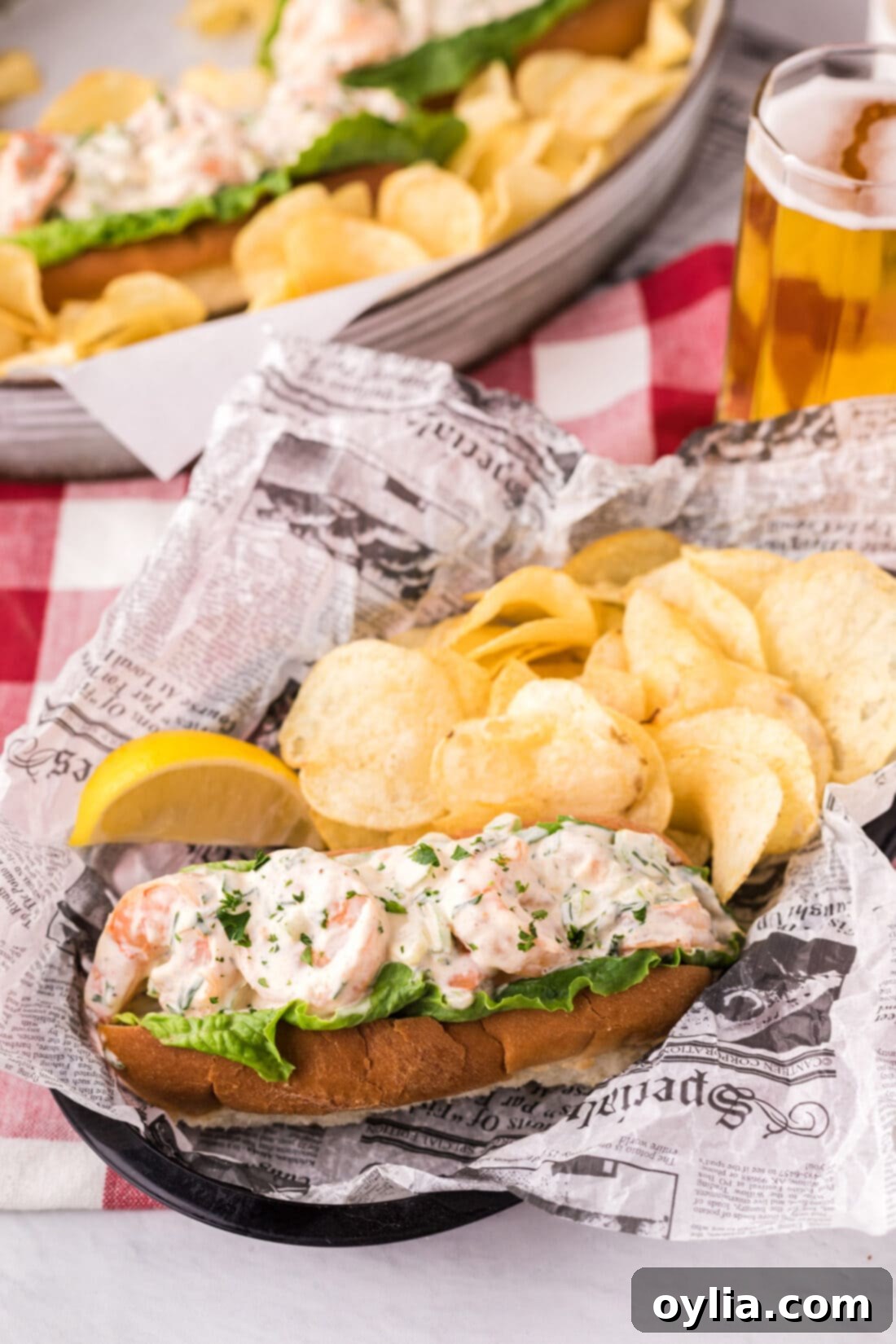 Gourmet Shrimp Roll 10 Shrimp Roll In a basket with potato chips and a lemon wedge