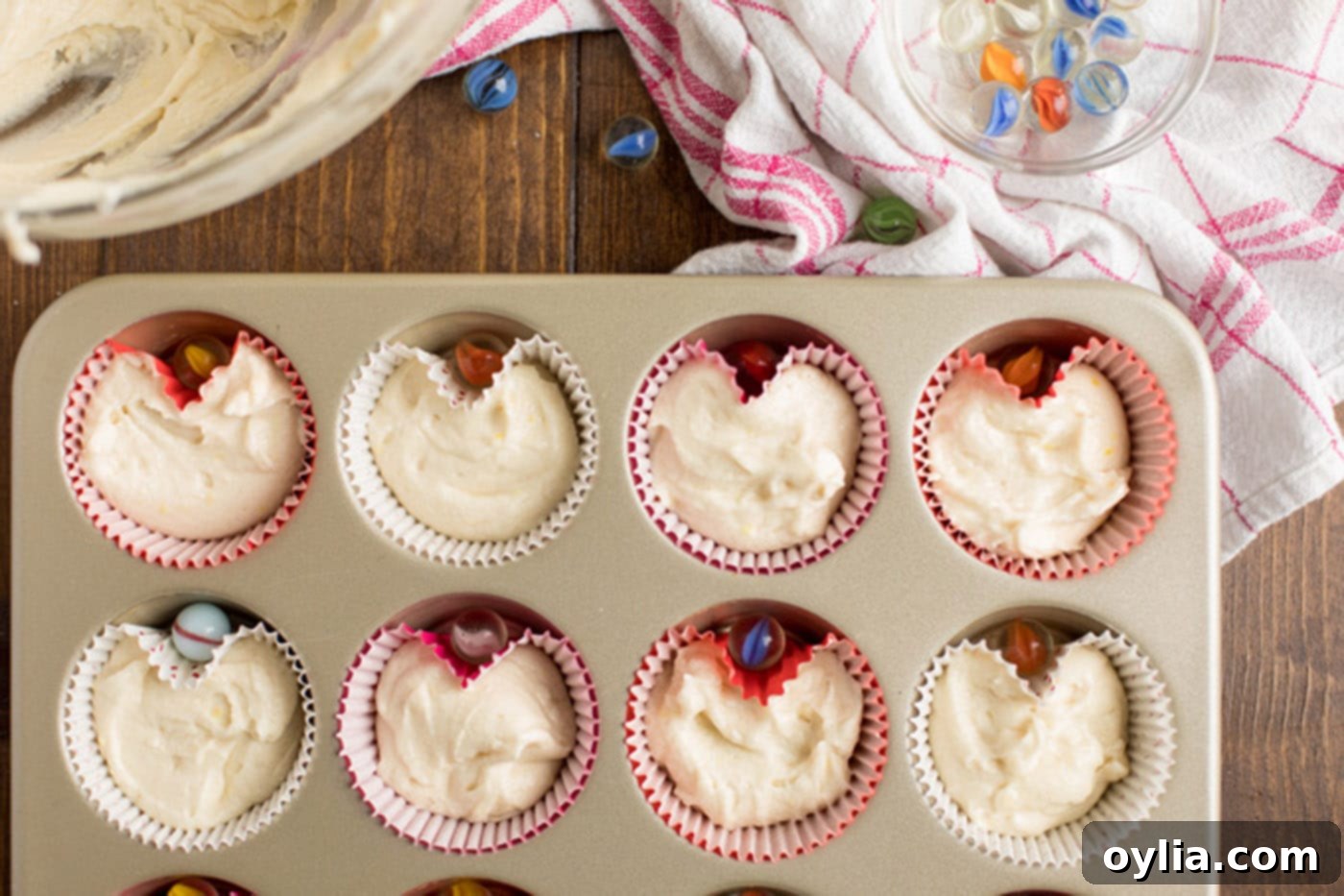 Cupcake batter in liners in a muffin pan