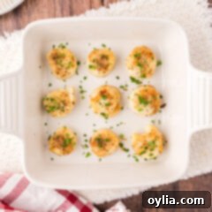 Baked Scallops in a square serving dish with a lemon wedge