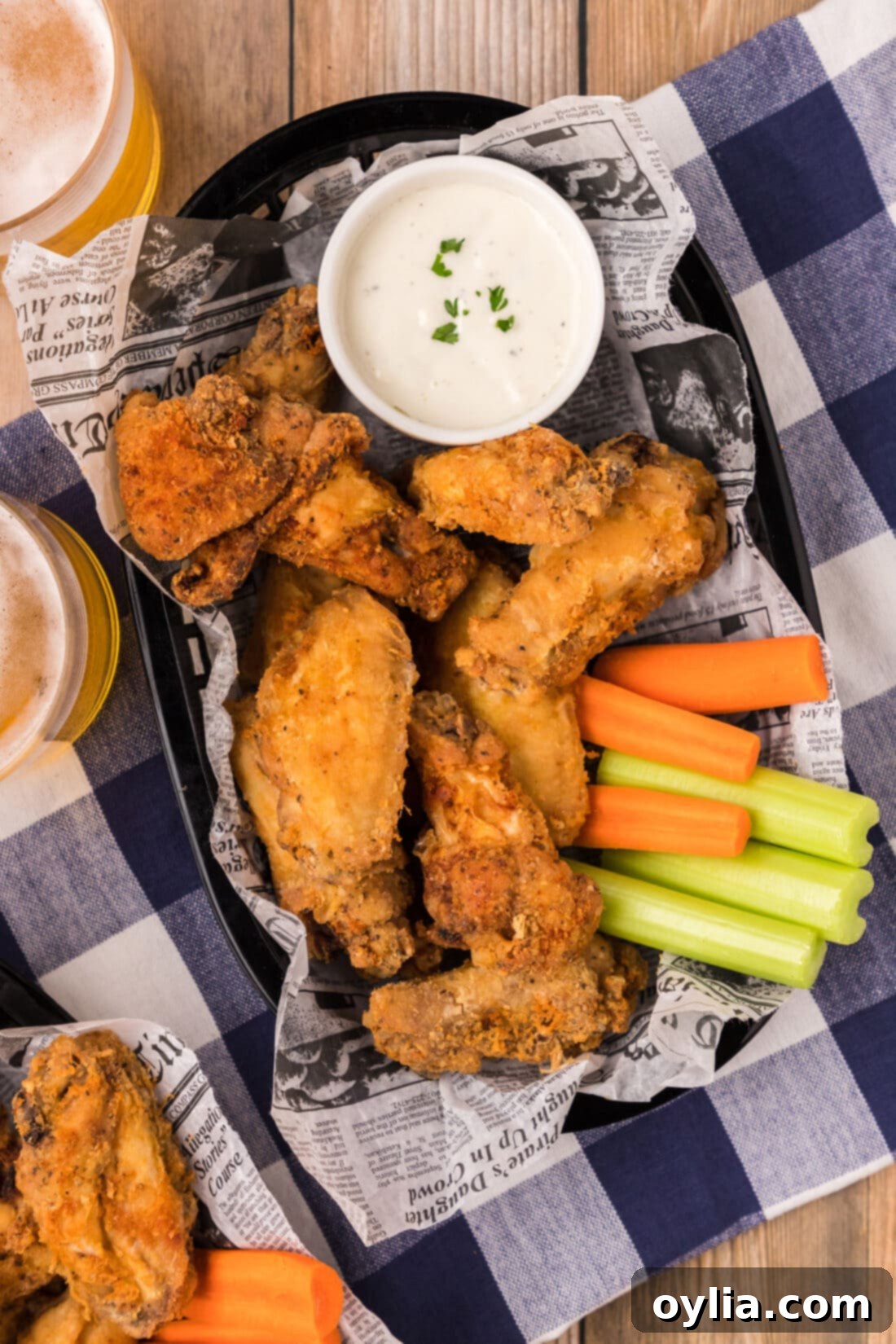 A large basket overflowing with perfectly golden-brown crispy fried chicken wings, invitingly ready to be served.