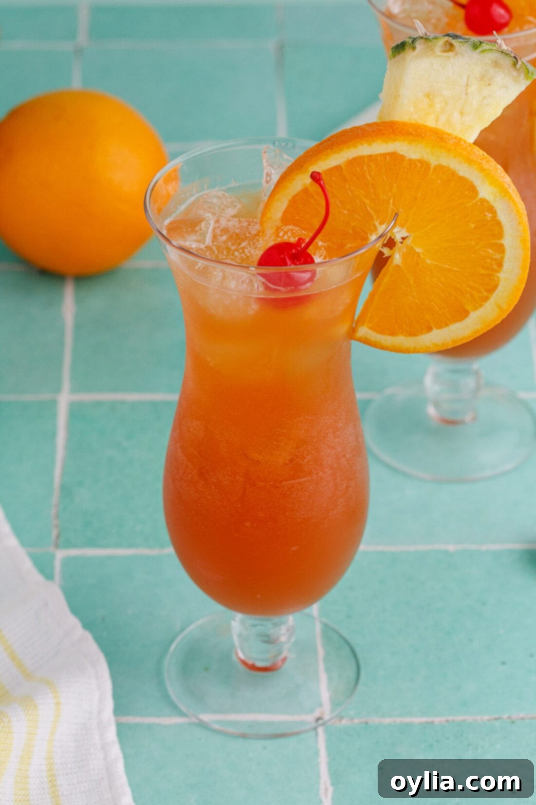 Rum Runner garnished with an orange wheel, pineapple wedge and cherry