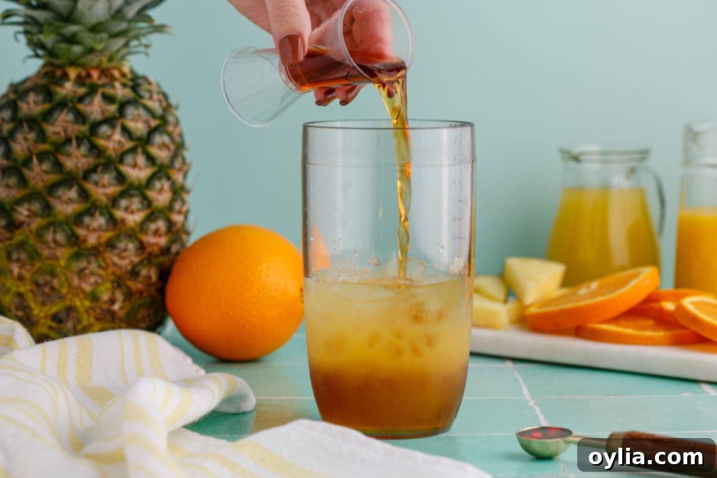 pouring rum into cocktail glass