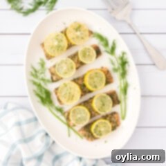 Overhead photo of a platter of Baked Dill Salmon with lemon slices, a perfect healthy dinner.