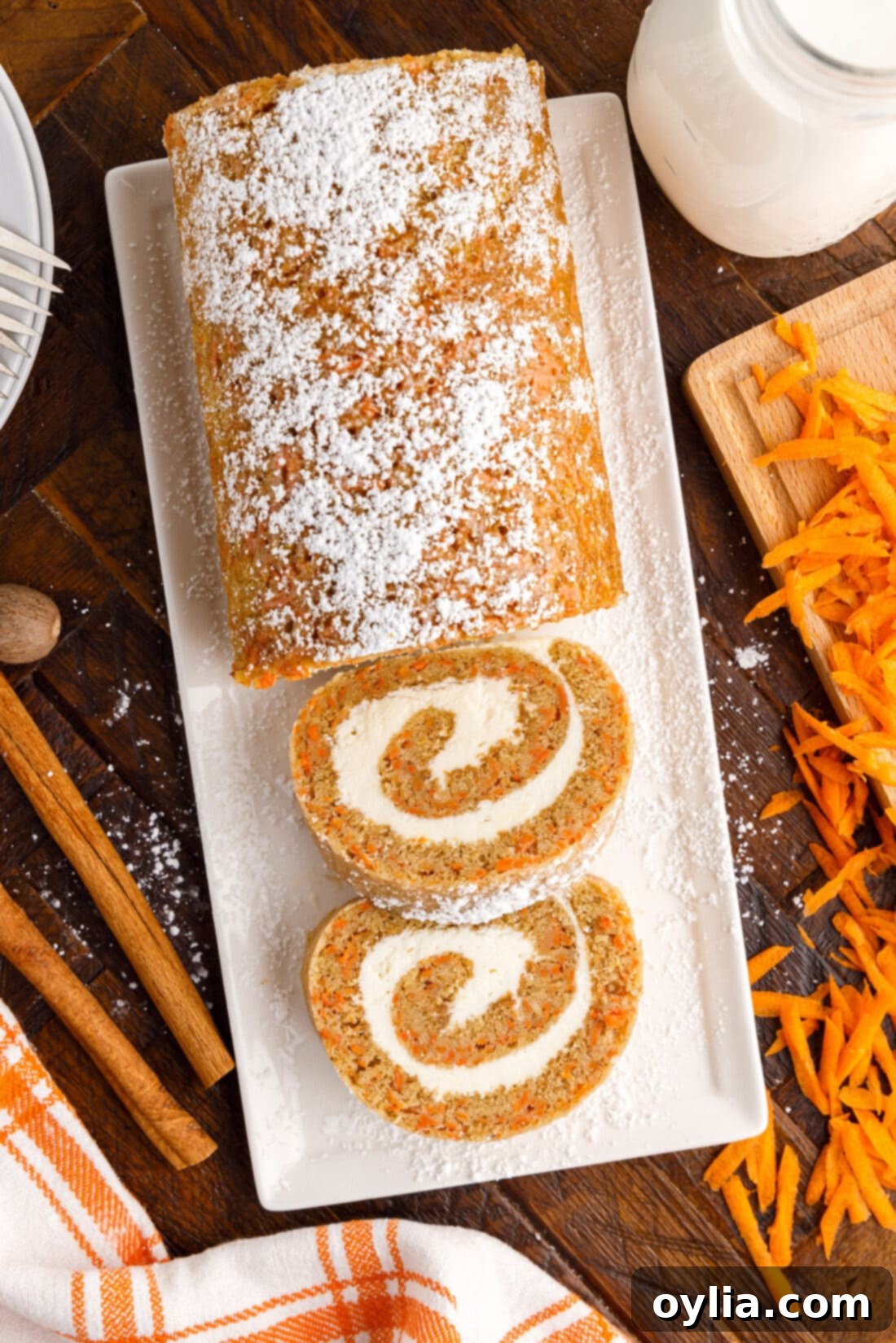 Carrot Cake Swiss Roll 2 Sliced Carrot Cake Roll on a serving platter, showing the beautiful swirl of cake and cream cheese