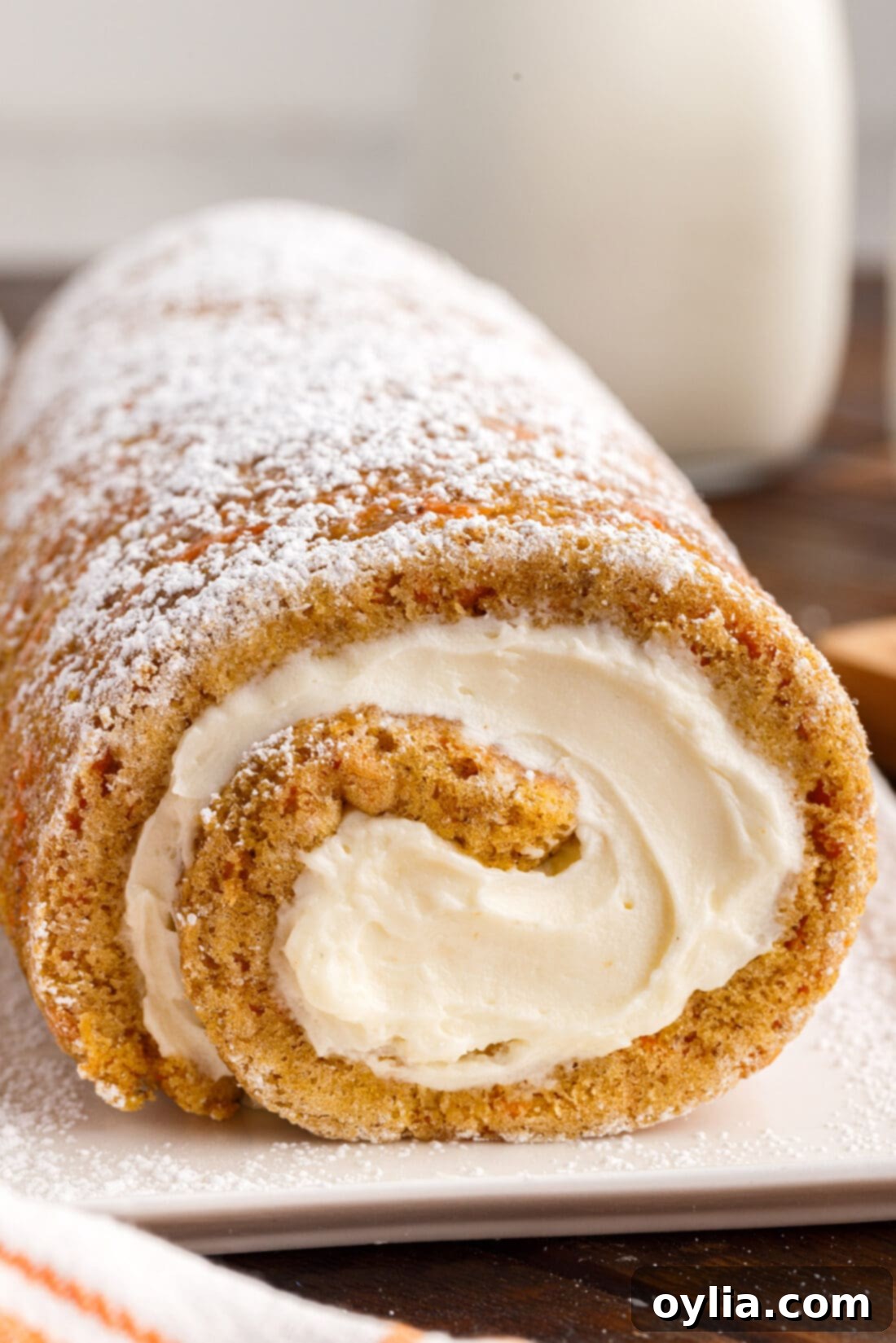 Carrot Cake Swiss Roll 3 Side view of a perfectly rolled Carrot Cake Roll, showing its cylindrical shape