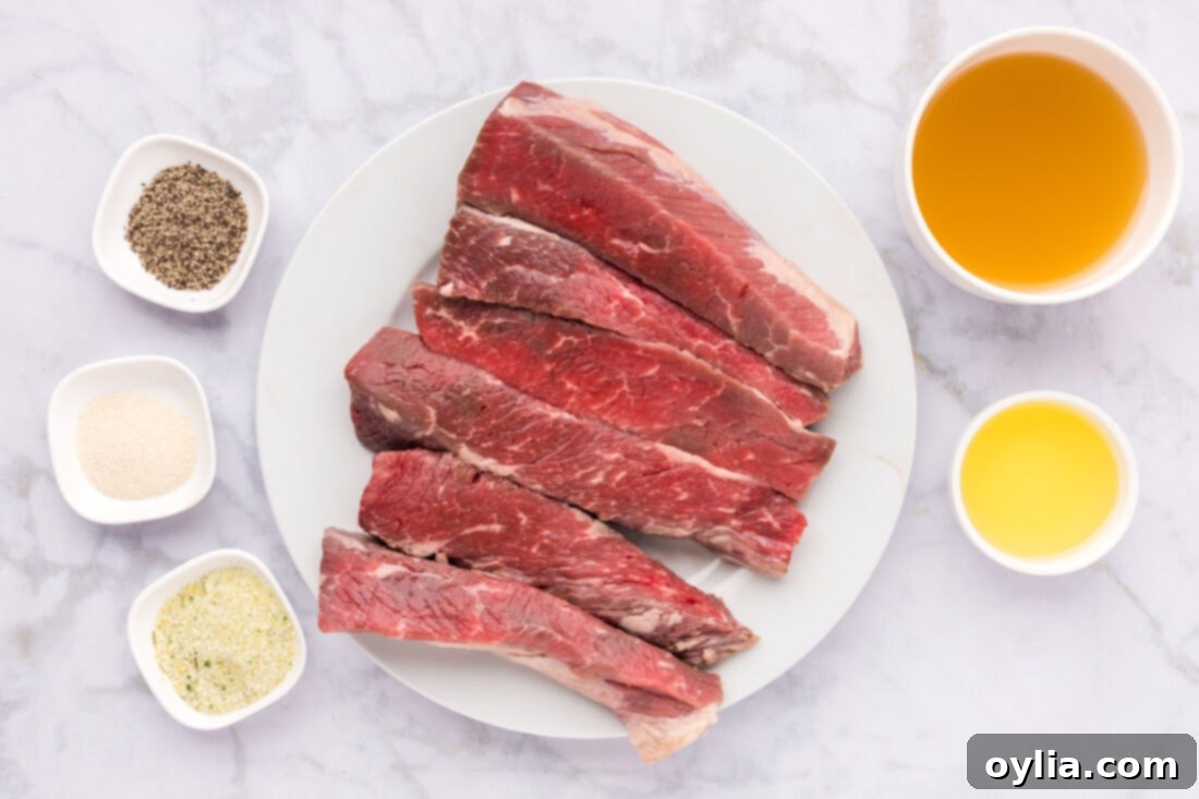 All the simple ingredients for cooking boneless beef short ribs laid out on a wooden cutting board.