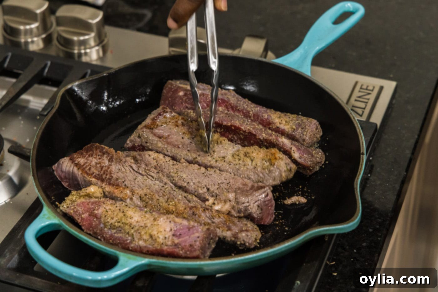 Searing boneless beef short ribs in a hot skillet to create a flavorful crust.