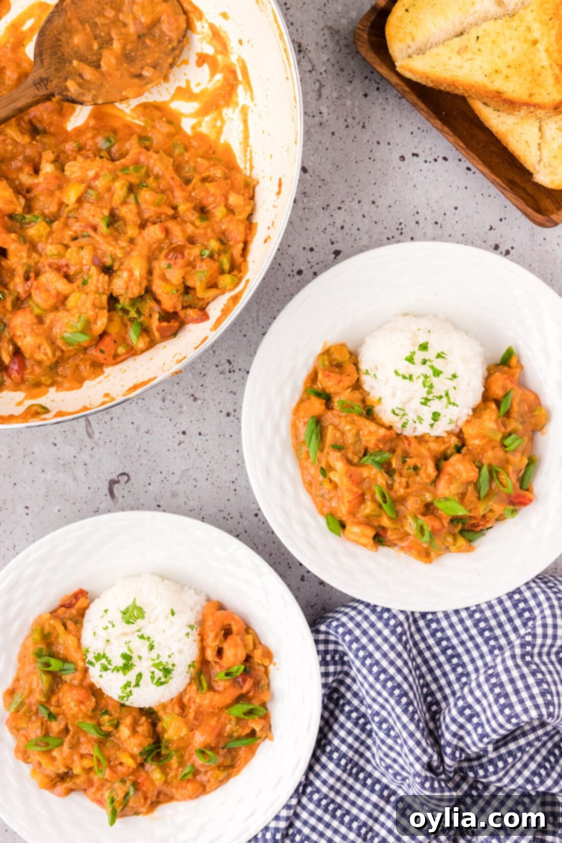 Two bowls of Crawfish Etoufee served with rice, garnished with green onions.